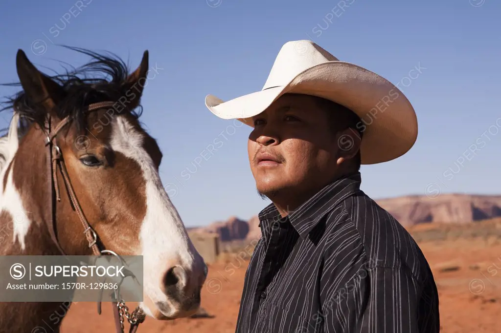 A cowboy and horse, Monument Valley Navajo Tribal Park, Monument Valley, Utah, USA