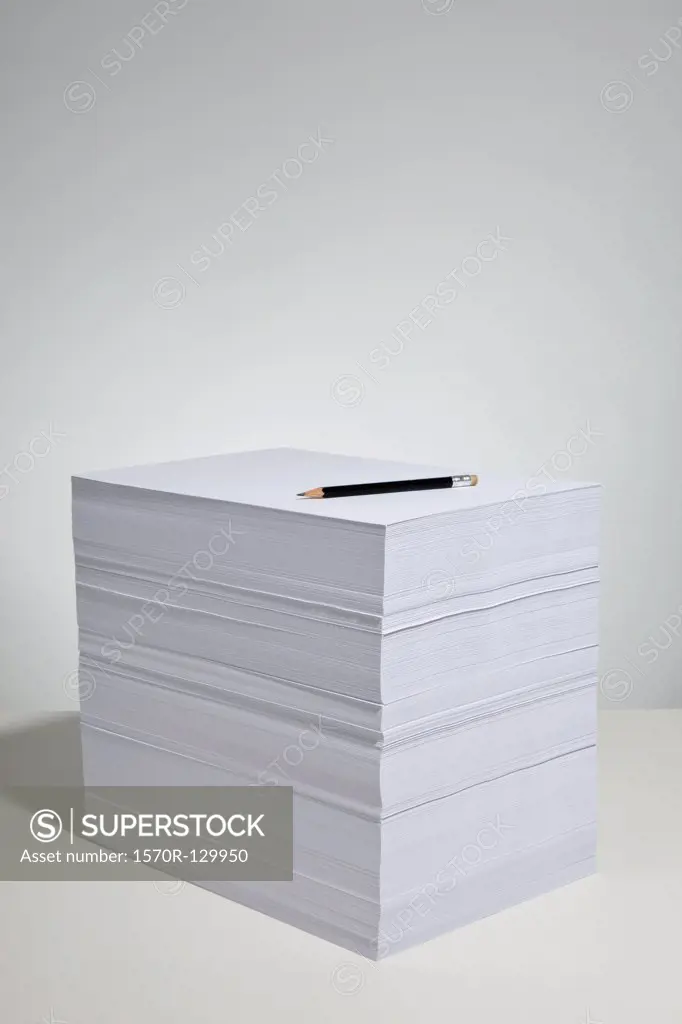 A pencil on a stack of paper