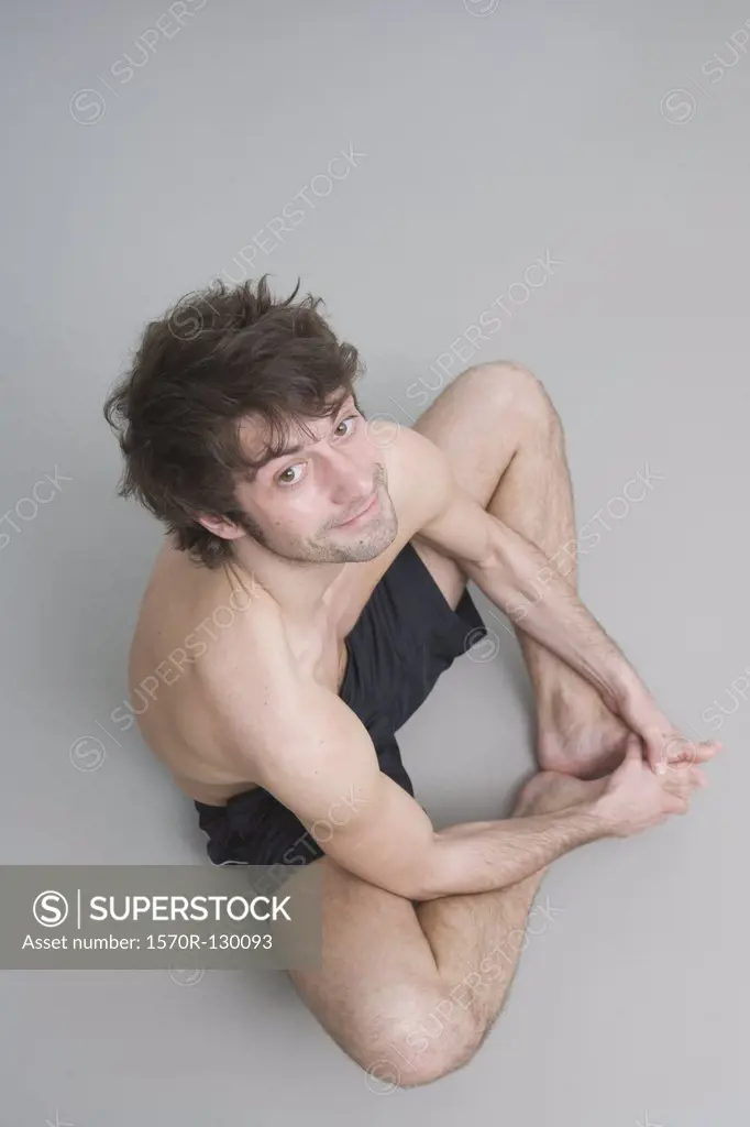 Young man stretching on floor