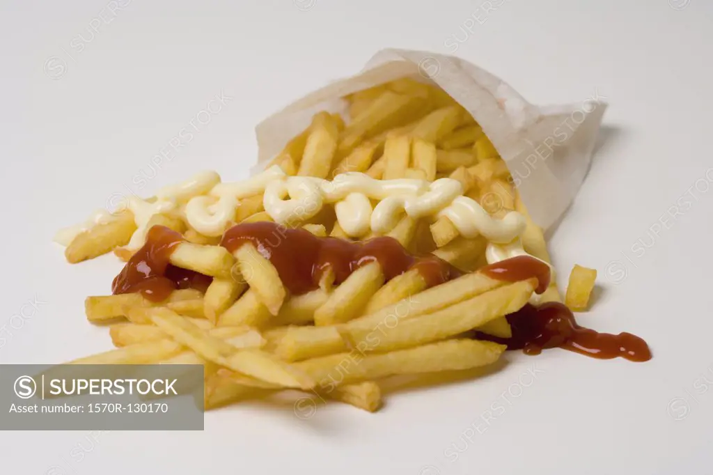 French fries with ketchup and mayonnaise in a paper bag