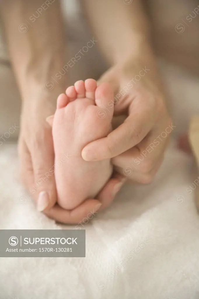 Mother massaging babys foot