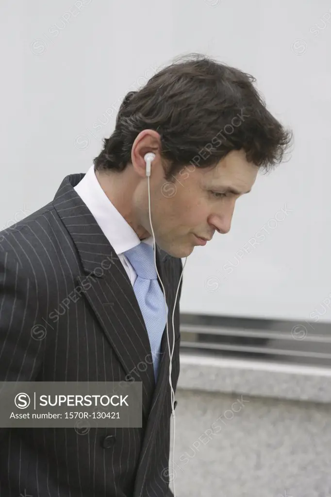 An English businessman listening to headphones