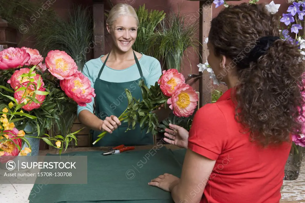 A woman buying flowers in a florists