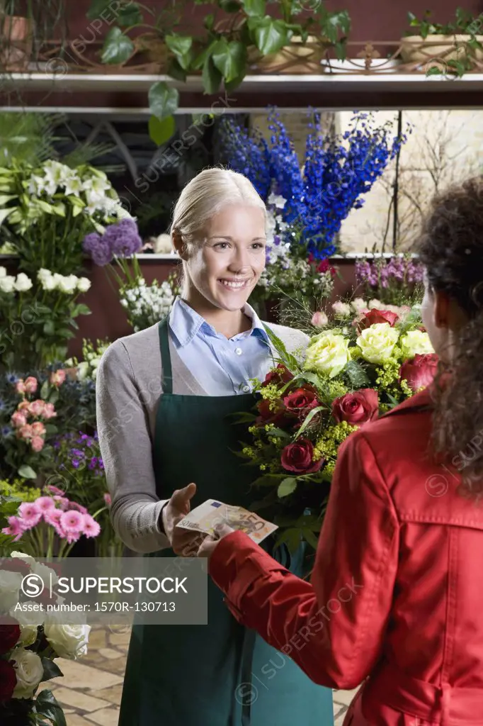 A woman buying flowers in a florist