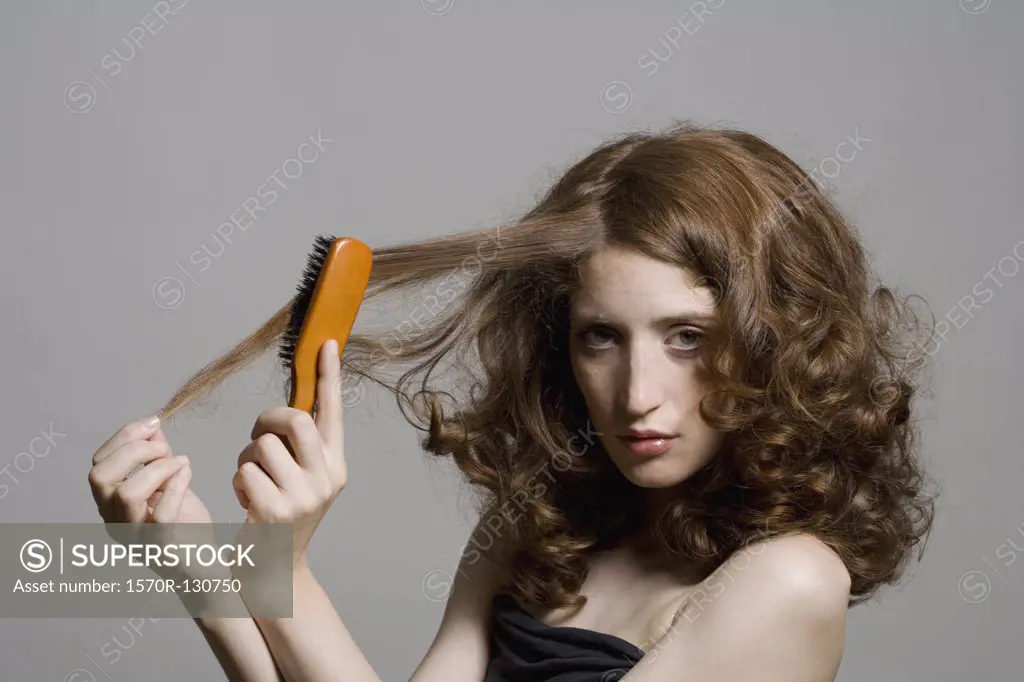 A young woman brushing her hair