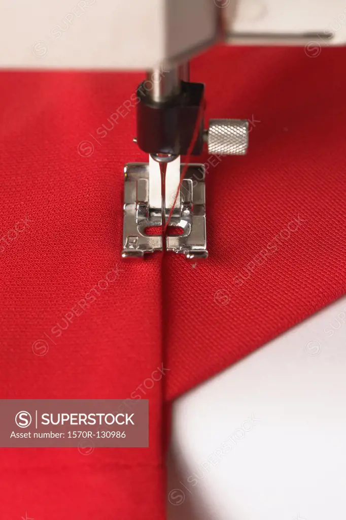 Detail of a sewing machine stitching fabric