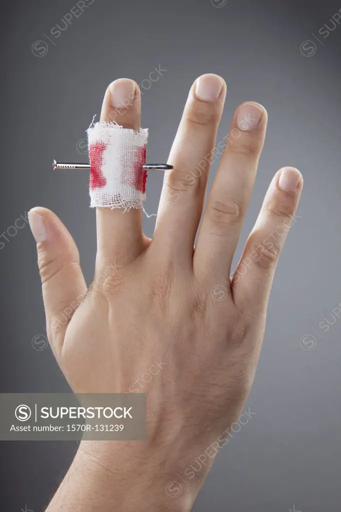 A nail piercing a finger