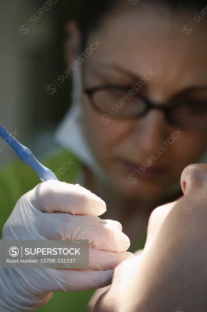 Close-up of a dentist working on a female patient