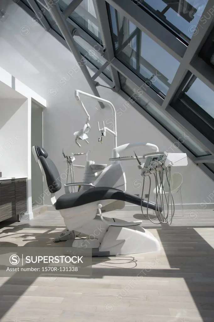 An empty chair in a dental examination room