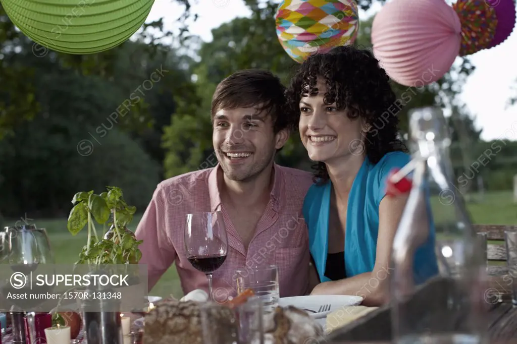A couple at a dinner party, outdoors