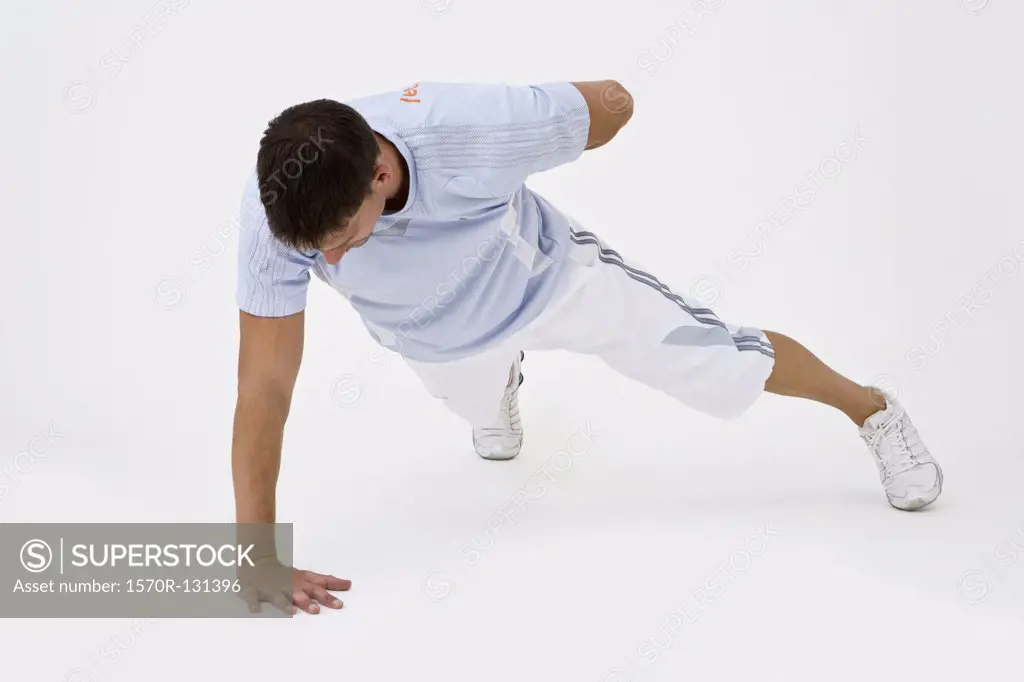 A man doing a one-arm push-up