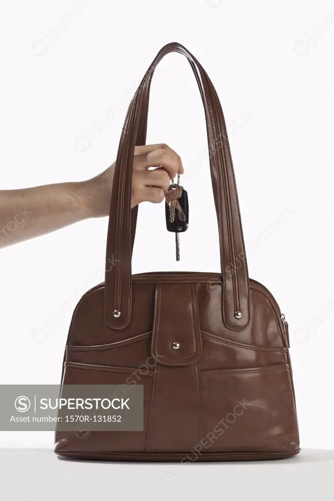 Detail of a man taking keys out of a handbag