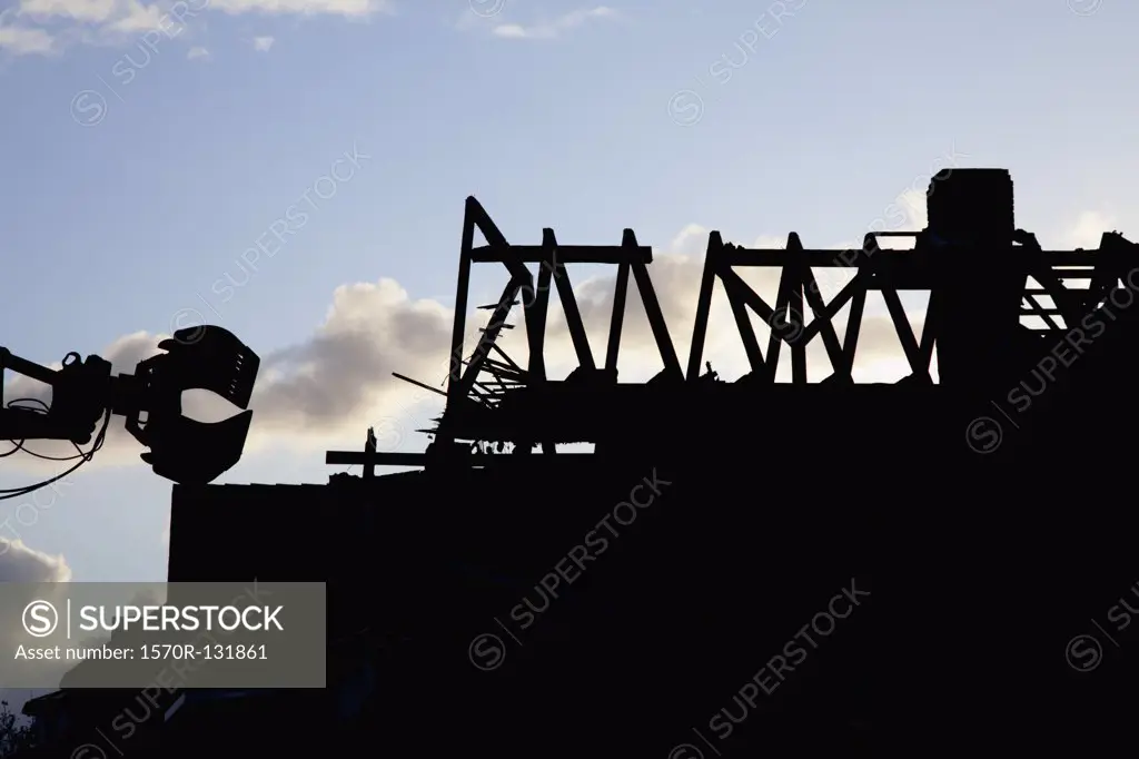 Silhouette of a building being demolished