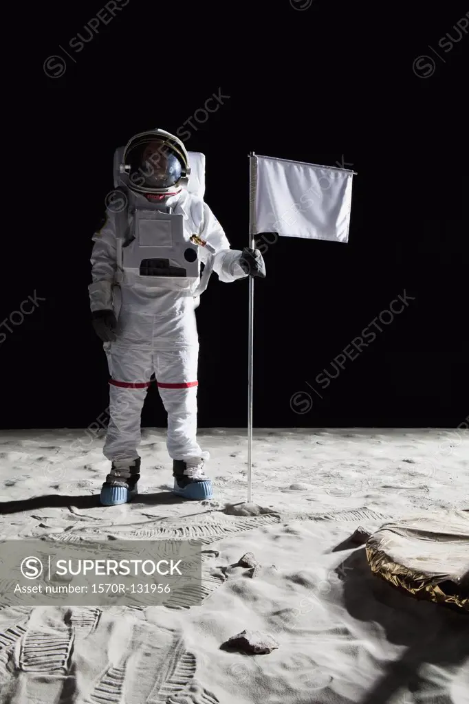 An astronaut standing next to a white flag