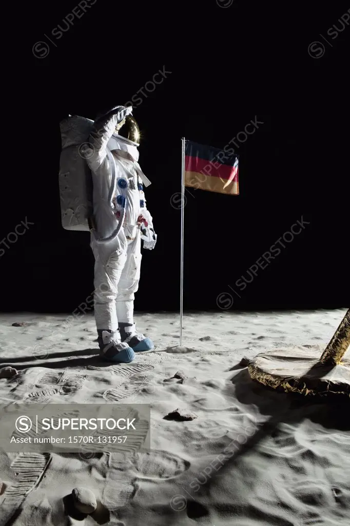 An astronaut standing near a lunar lander salutes an German flag