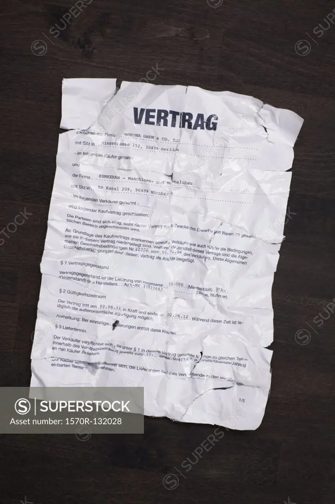 A wrinkled, torn, German sales contract taped together and flattened out