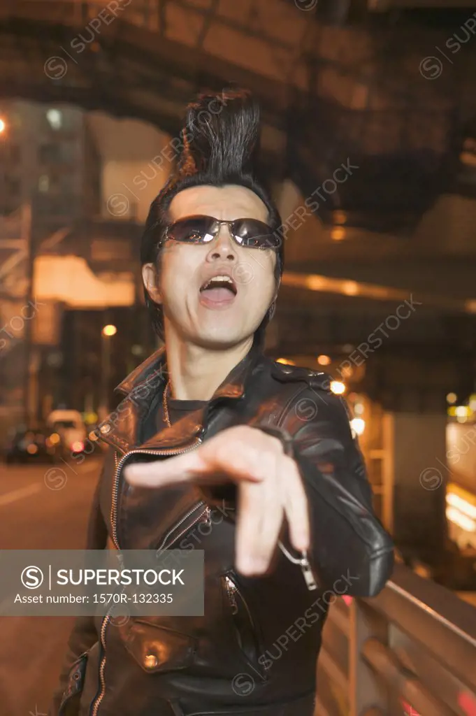 Punk rocker pointing at camera, Tokyo, Japan