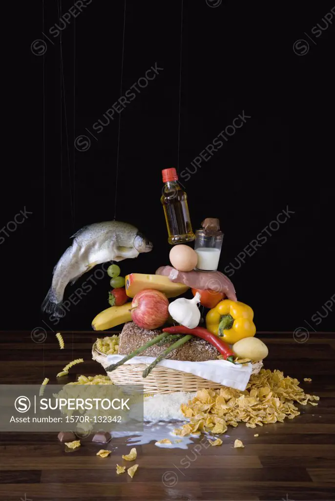 Assortment of raw food stacked up in basket on table