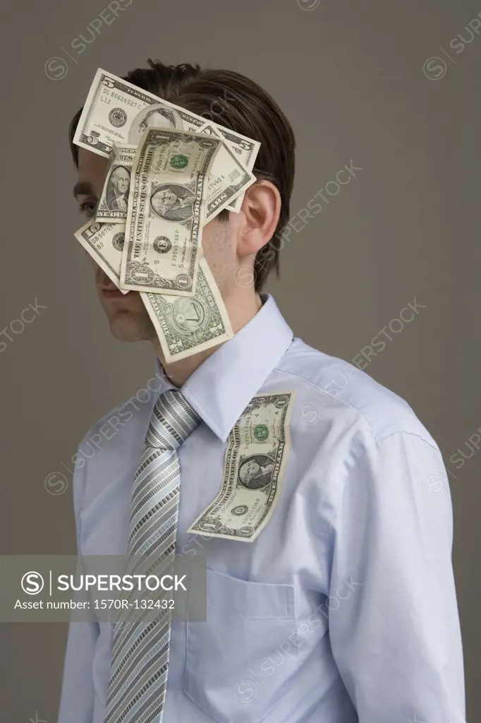 Businessman with money stuck on his head