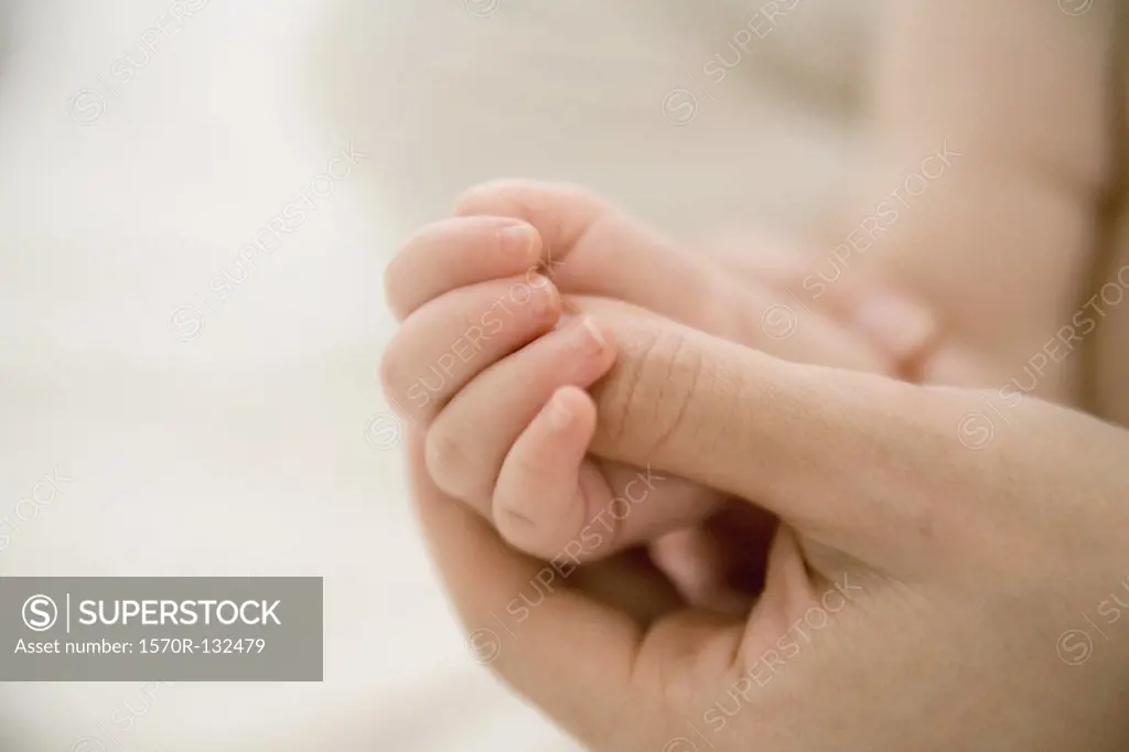 Mother massaging babys hand