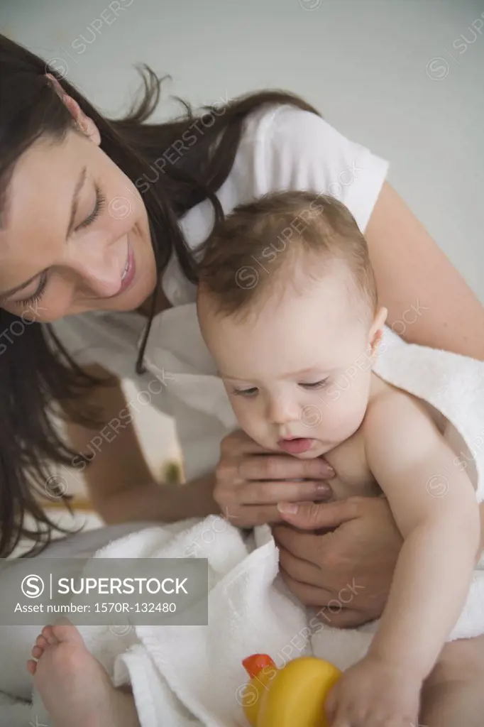 Mother drying baby with a towel