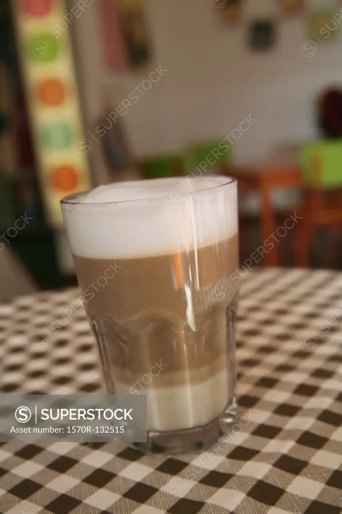 Cup of coffee on checked tablecloth
