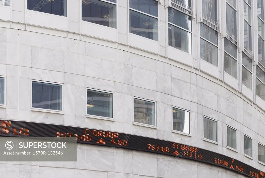 Digital display of stock market figures on building exterior, London, England