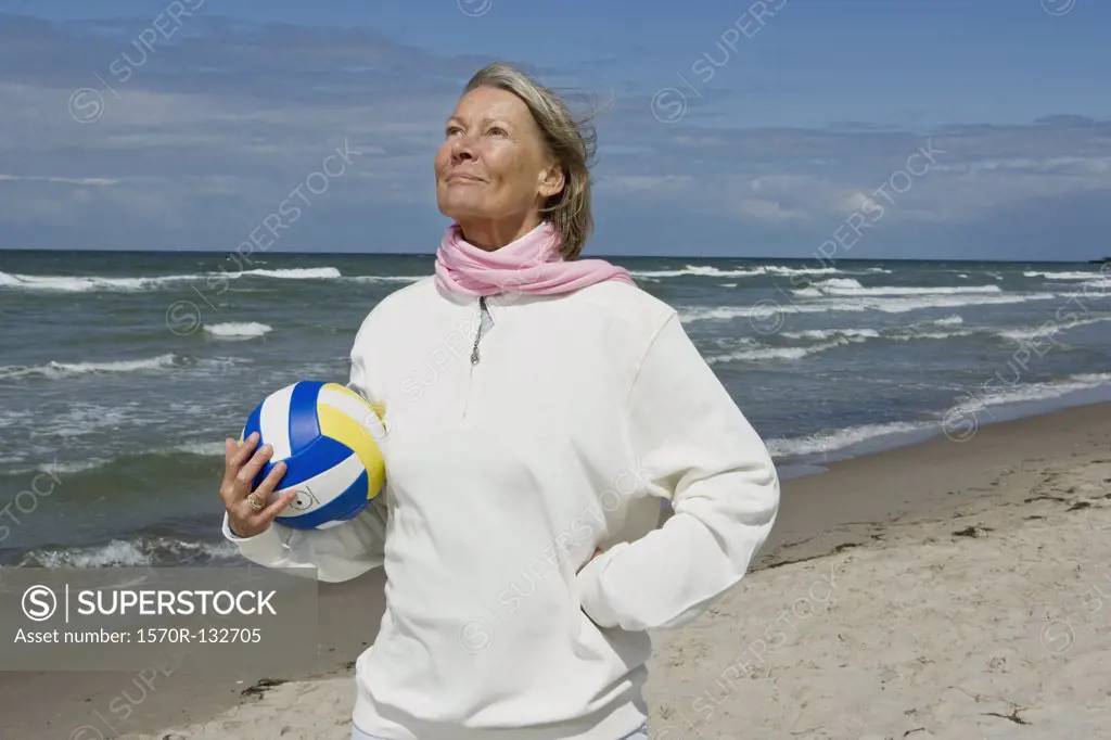 A senior woman holding a soccer ball