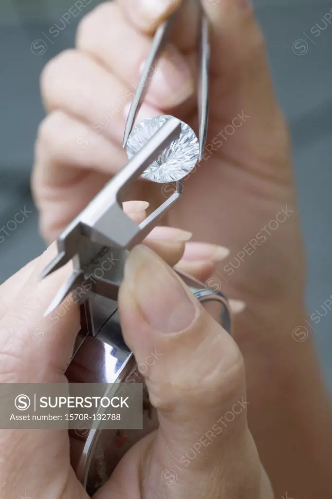 A jeweler using a diamond gauge on a diamond