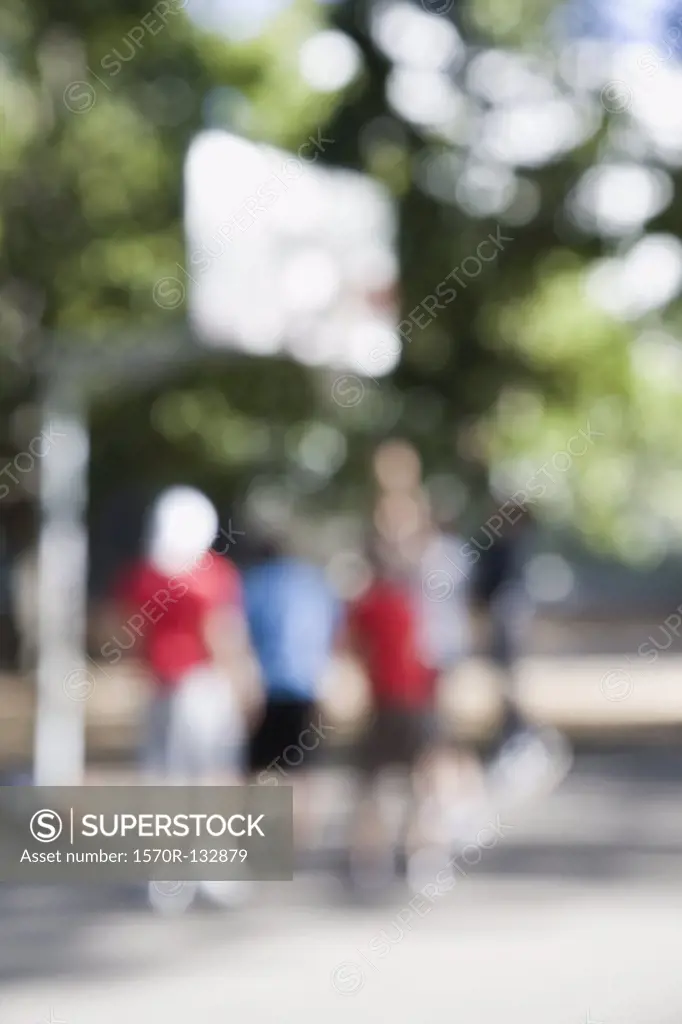 People playing basketball, outdoors, defocused