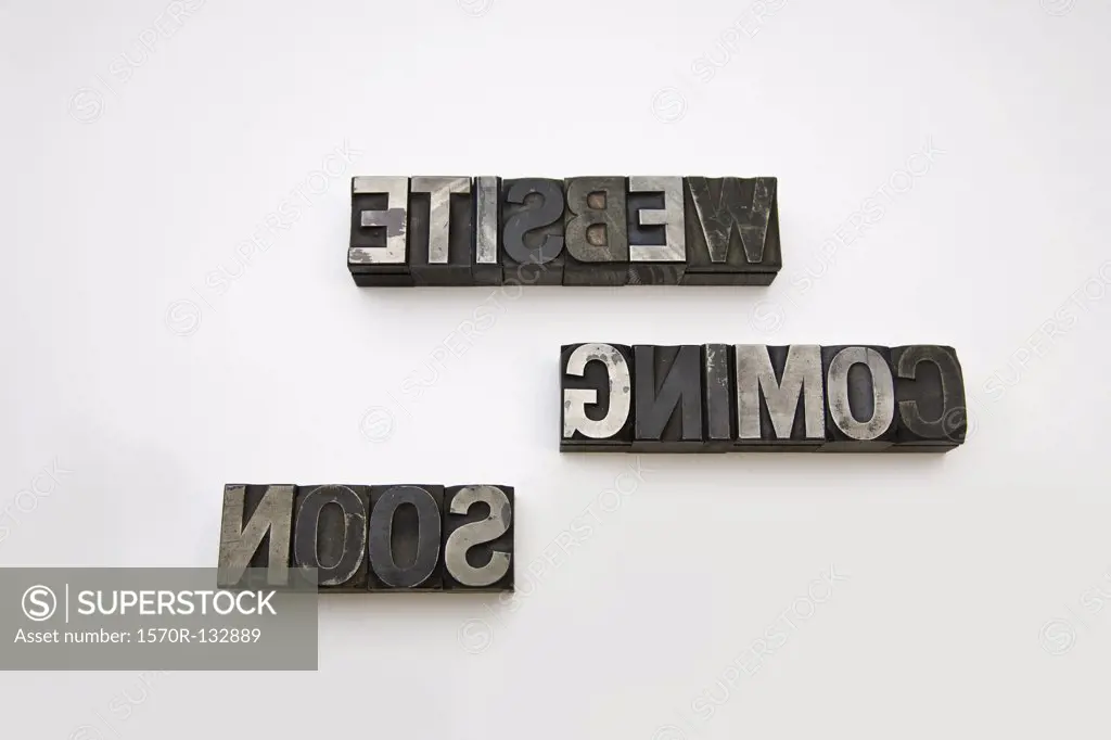 WEBSITE COMING SOON written backwards in metal letterpress letters