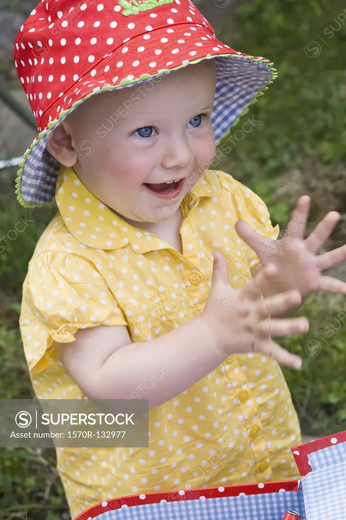 Portrait of a toddler clapping, close-up