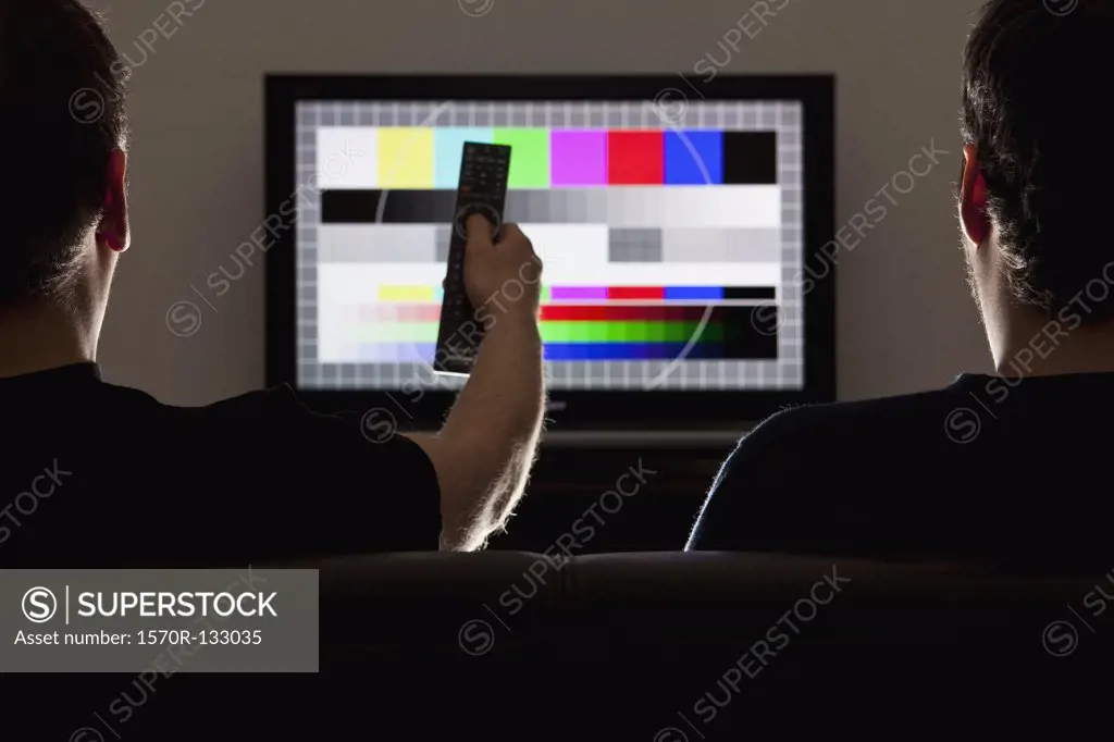 Two men watching a test pattern on a television