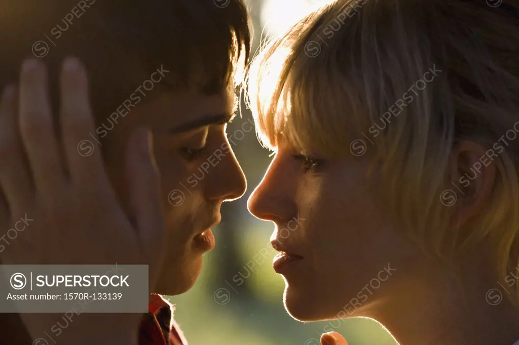 A passionate young couple face to face, extreme close up