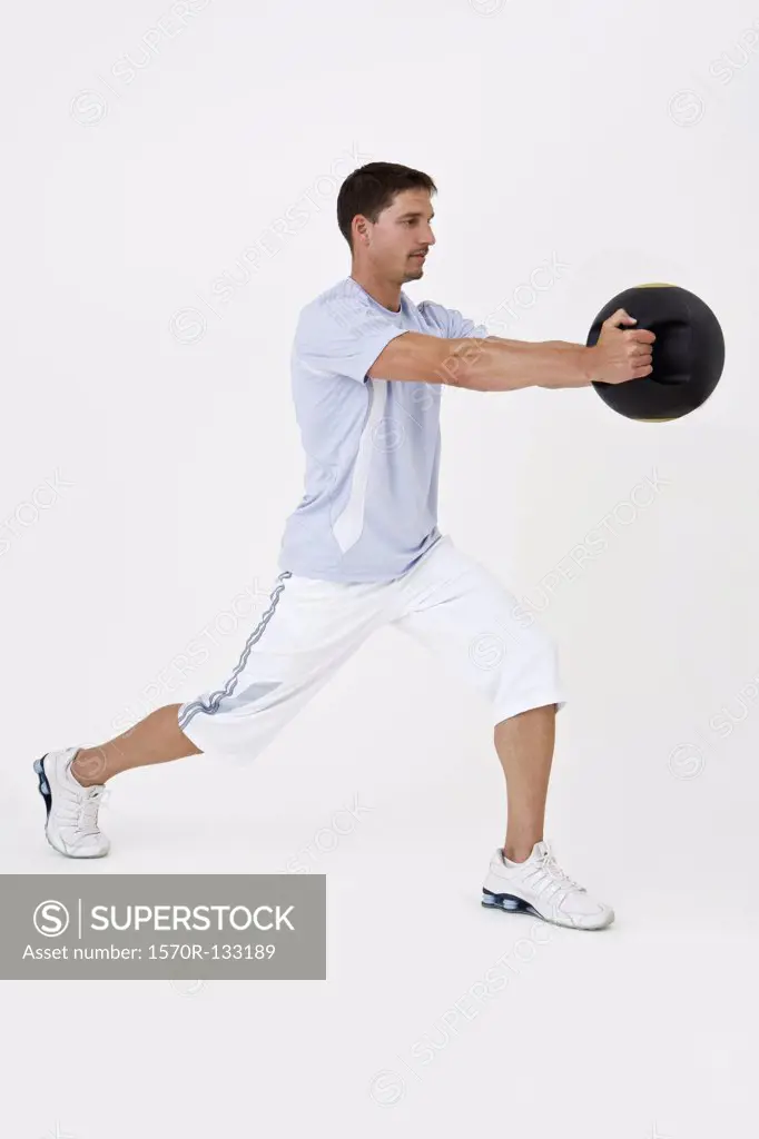 A man exercising with a medicine ball