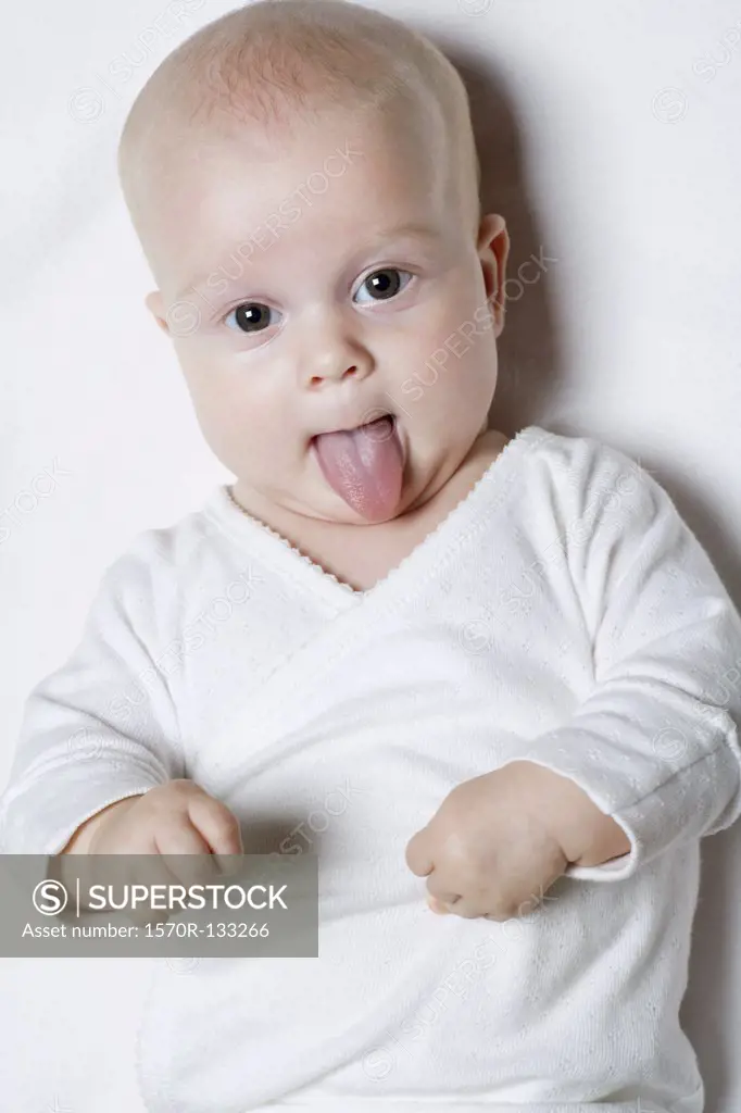 A baby sticking out her tongue, portrait
