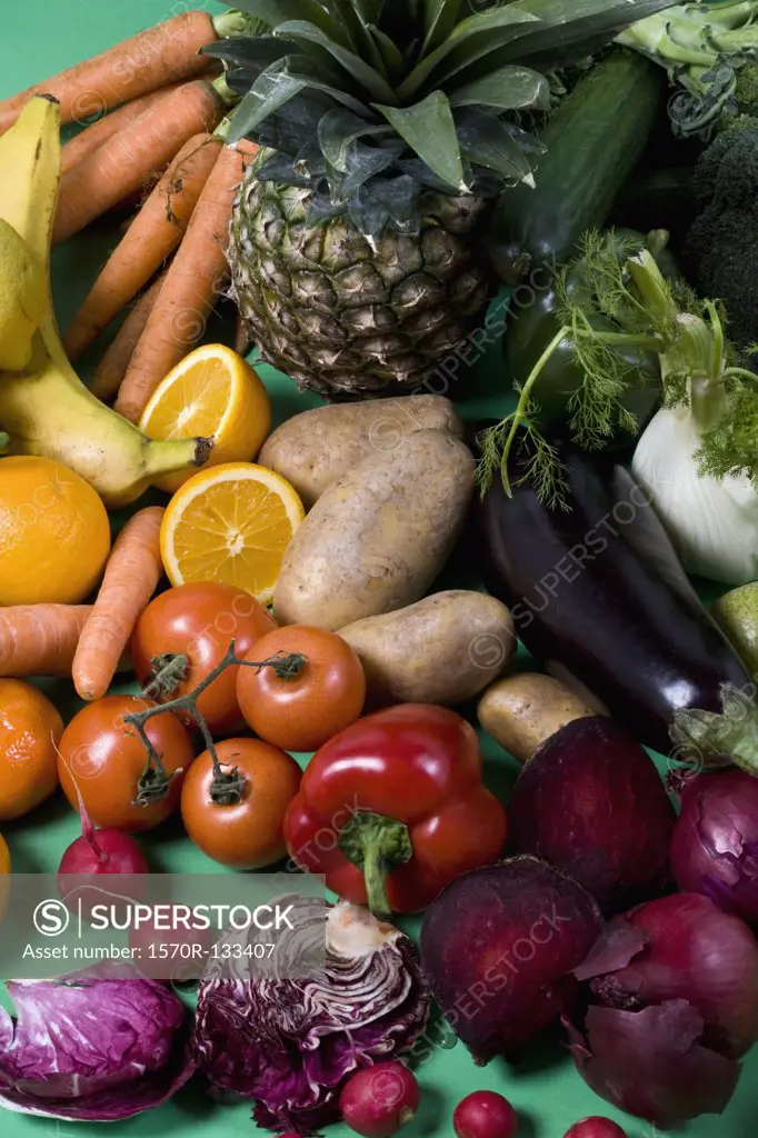 Arrangement of fruits and vegetables on a green background
