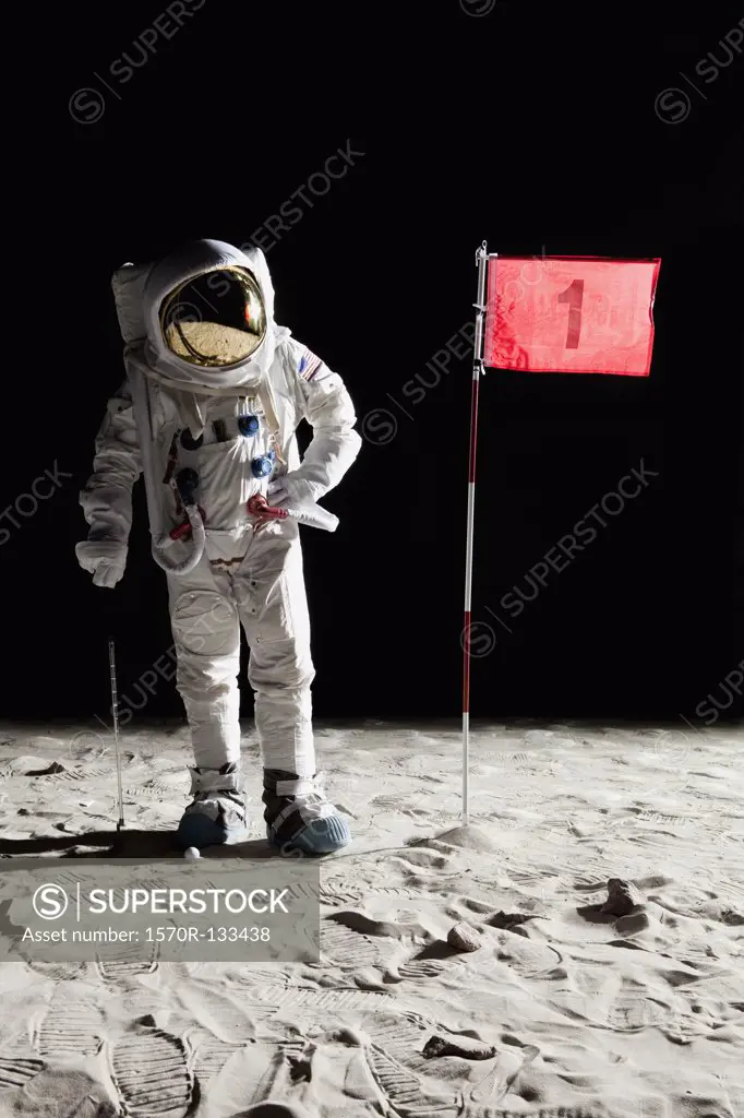 An astronaut on the moon standing next to number 1 hole flag
