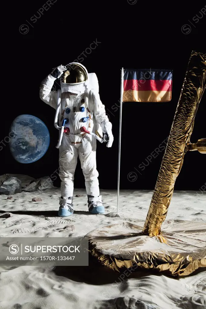 An astronaut standing near a lunar lander salutes an German flag