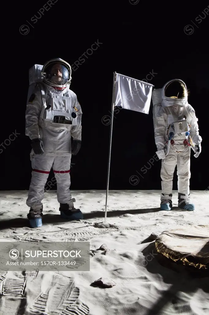 Two astronauts on the moon, a blank white flag in between them
