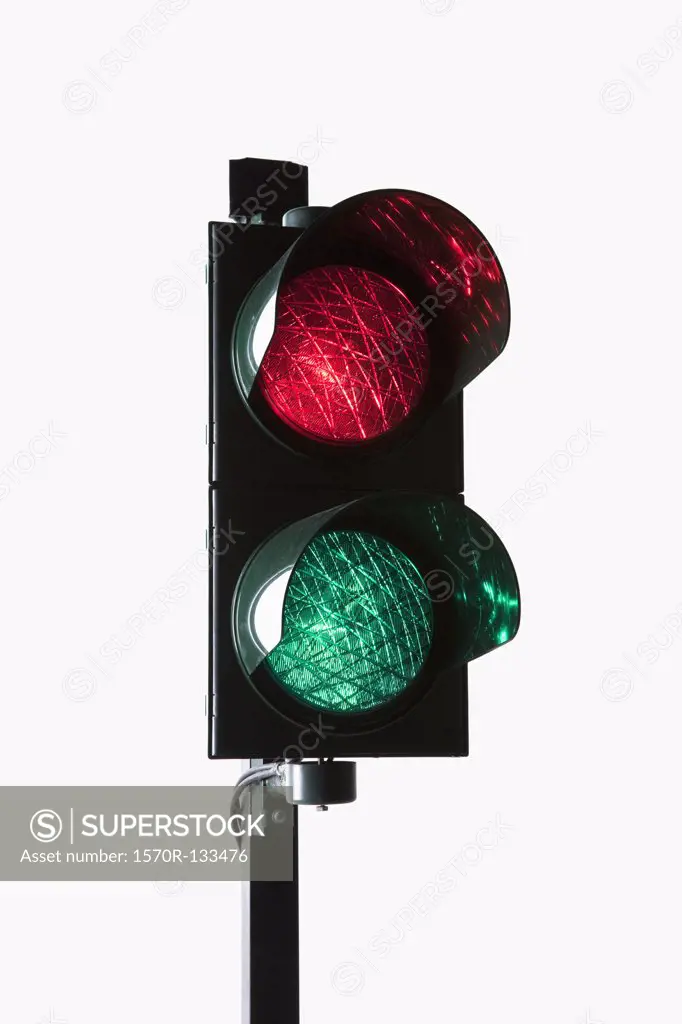 A stoplight with both the red light and green light illuminated
