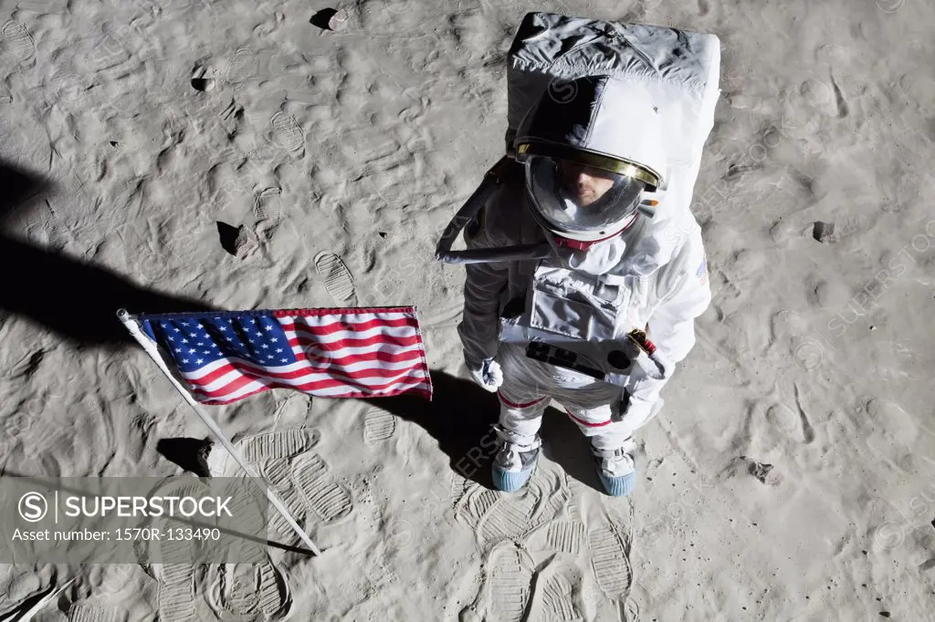 An astronaut on the surface of the moon next to an American flag
