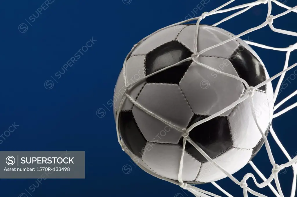 A soccer ball in a net, close-up