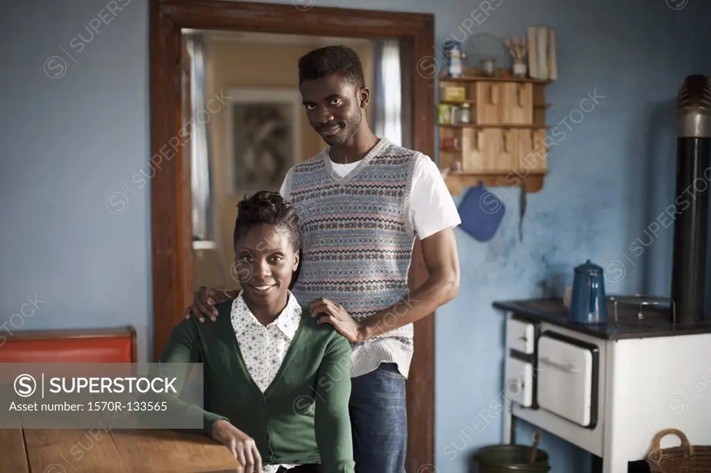 Portrait of a young couple in a domestic kitchen