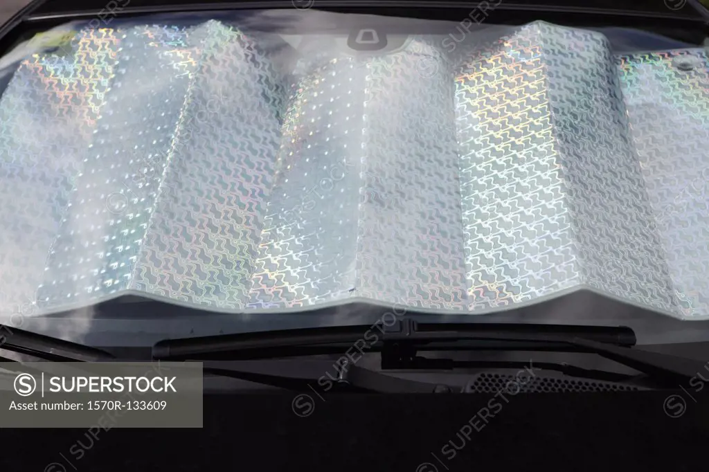 Detail of a car windshield being protected from the sun