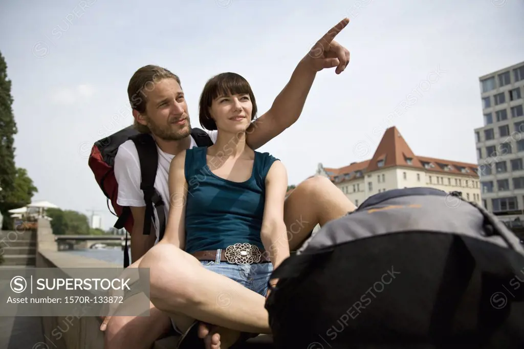 A young couple relaxing by the Spree river, Berlin, Germany