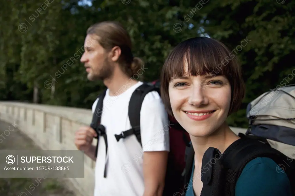 A young backpacker woman with her boyfriend, focus on woman