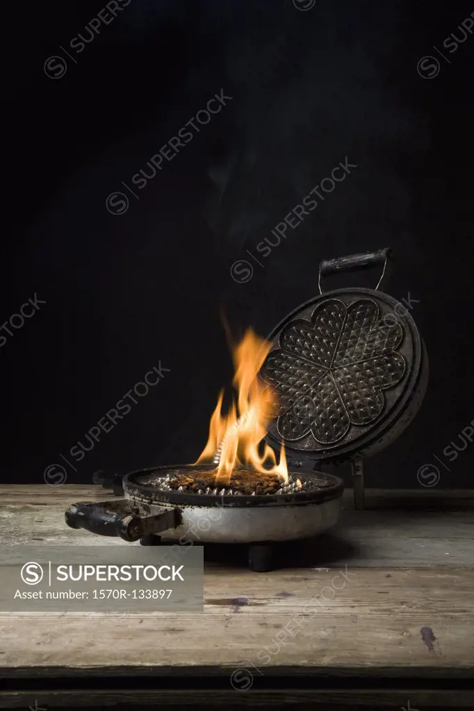 A waffle iron on fire