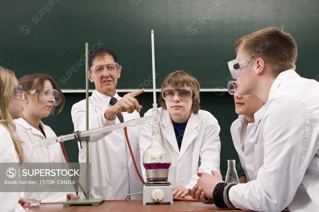 A teacher showing his students a chemistry experiment