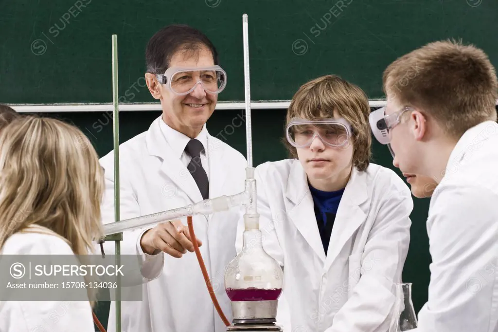 A teacher showing his students a chemistry experiment